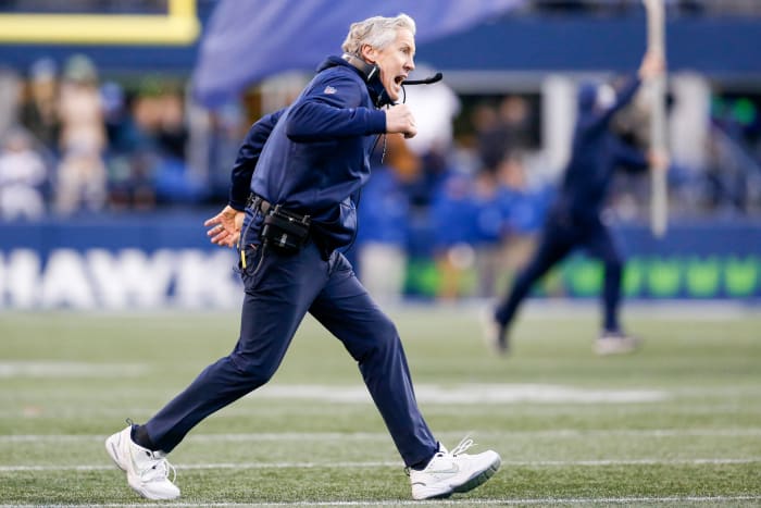 Seattle Seahawks head coach Pete Carroll runs onto the field.